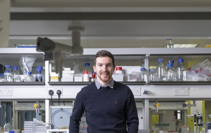 Dr Mark OSullivan, a lead investigator at INFANT, standing in a lab with electrical engineering equipment