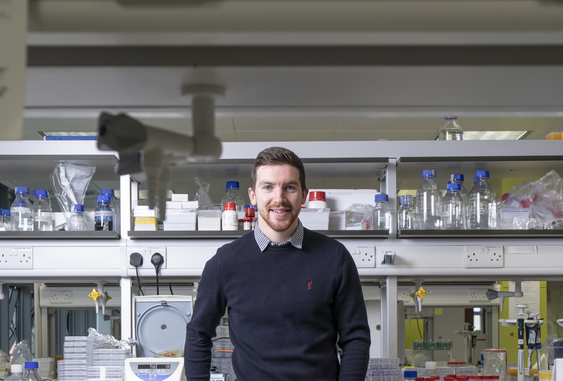 Dr Mark OSullivan, a lead investigator at INFANT, standing in a lab with electrical engineering equipment