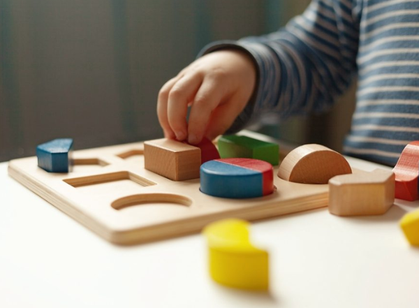 baby hand holding blocks