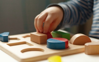 baby hand holding blocks